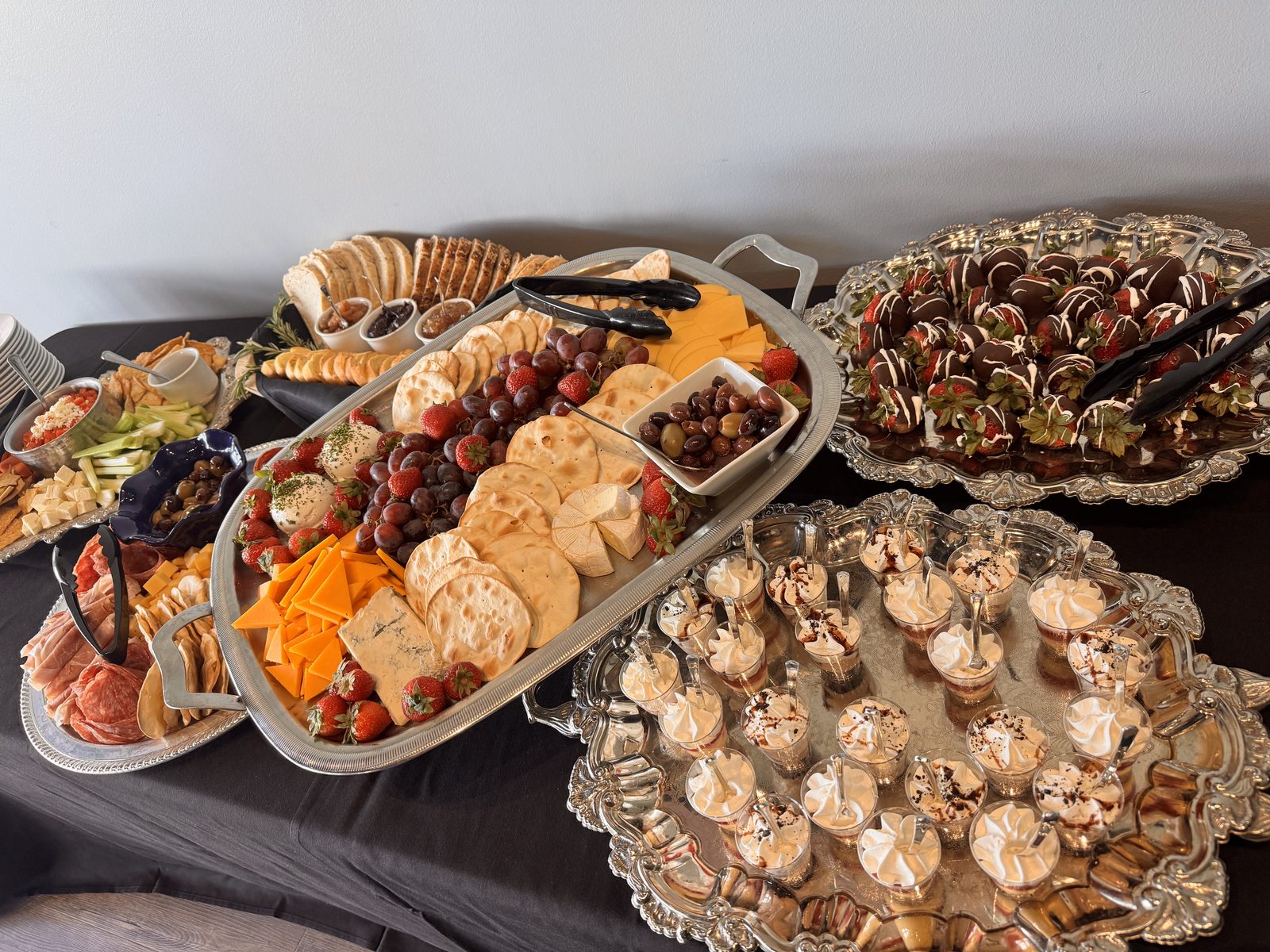 A catered spread of charcuterie, cheese, and desserts at The Pond